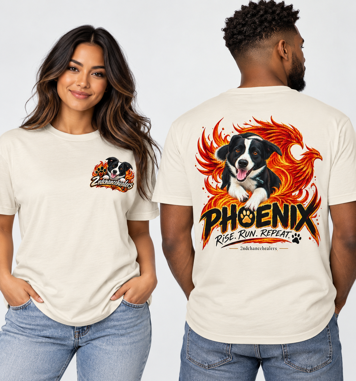 A man and a woman modeling a cream-colored t-shirt. The woman shows the front of the shirt with a small graphic on the left chest, and the man shows the back of the shirt featuring a large graphic of a black and white dog surrounded by orange flames with the text 'PHOENIX RISE RUN REPEAT'.