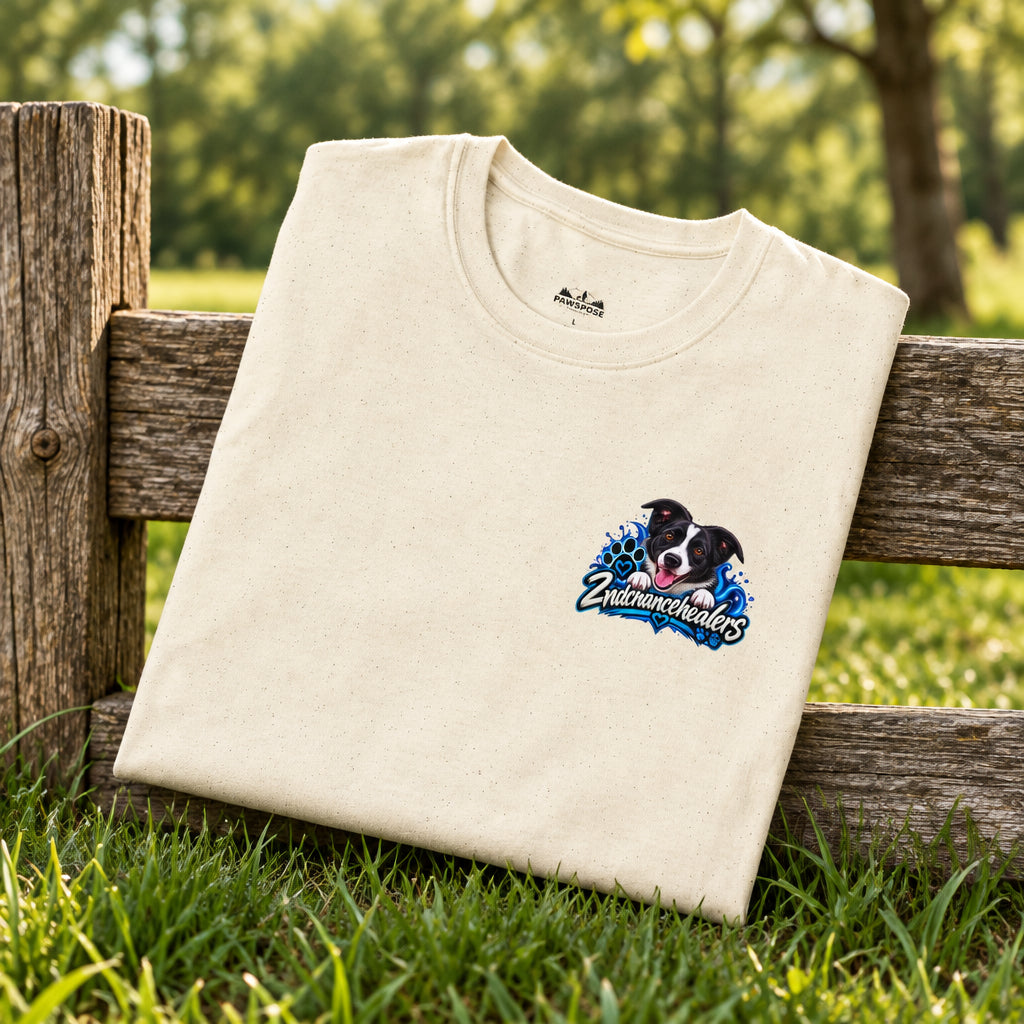A folded cream-colored crewneck t-shirt with a small graphic on the left chest showing a black and white dog with the text 'Underdogs' in blue and white.