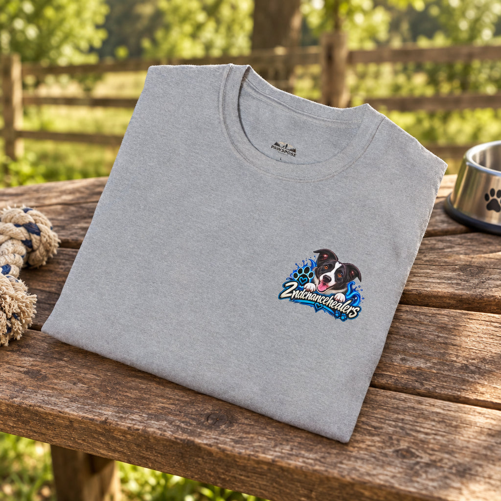 A folded light gray crewneck t-shirt with a colorful graphic on the left chest featuring a dog and the text 'ZINCMEGAHENS'.